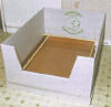 To assemble, the lid is taken off the small and medium boxes, the walls are unfolded, stood in the box and lugs in the base are pushed through slots in the walls, the front flap is folded down which forms the dams entrance way. The corners of the waterproof sheet are then pinched together and folded towards each other on the outside of the formed tray. The tray is then slid down into the box which forms a waterproof base and also holds down the fixing lugs and the front flap. 

There are perforations below the front flap which can be torn down as the puppies get older so they can get out of the box.

Available in four sizes<BR>
<UL>
<LI>Small</LI> = 21in x 21in x x16in</LI>
<LI>Medium = 7.5in x 27.25in x 19.25in</LI>
<LI>Large = 42.5in x 34in x 22in</LI>
<LI>X Large = 8.5 in x 36.5in x 22.5in</LI>
</UL>
